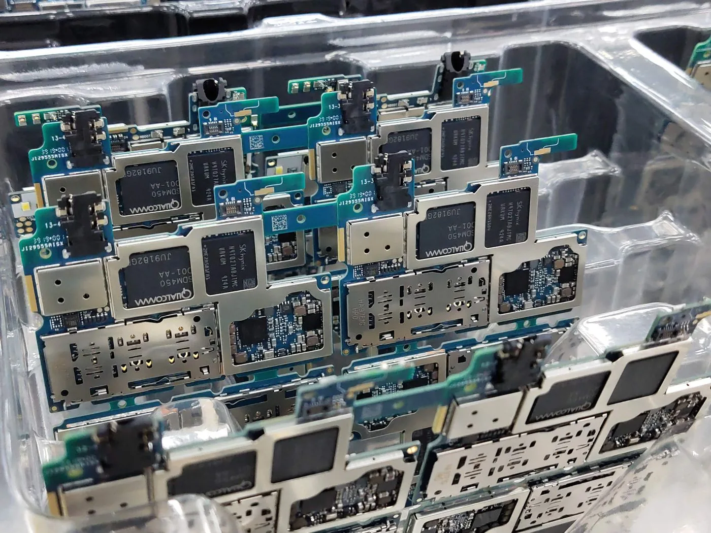 Sorted smartphone circuit boards in a recycling workshop